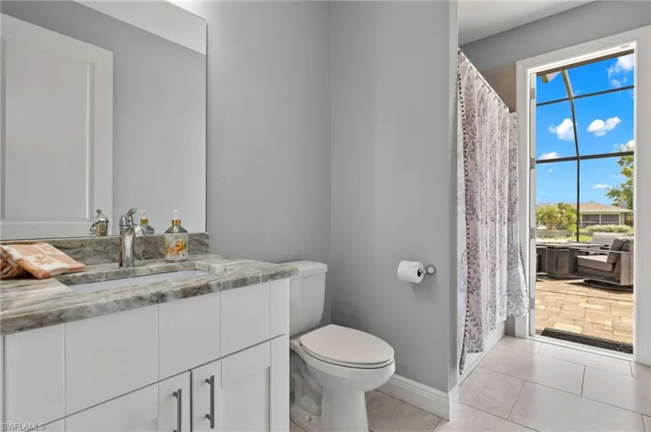 Bathroom with vanity, toilet, and tile patterned floors