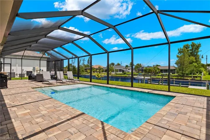 View of pool featuring a patio area, a lanai, and a yard