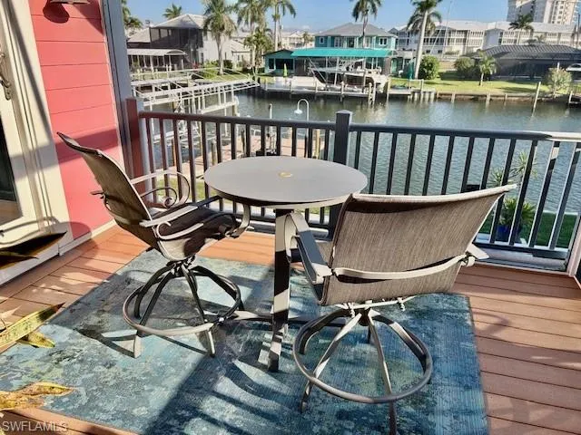 Screened lanai sitting area wih views of pool , and canal