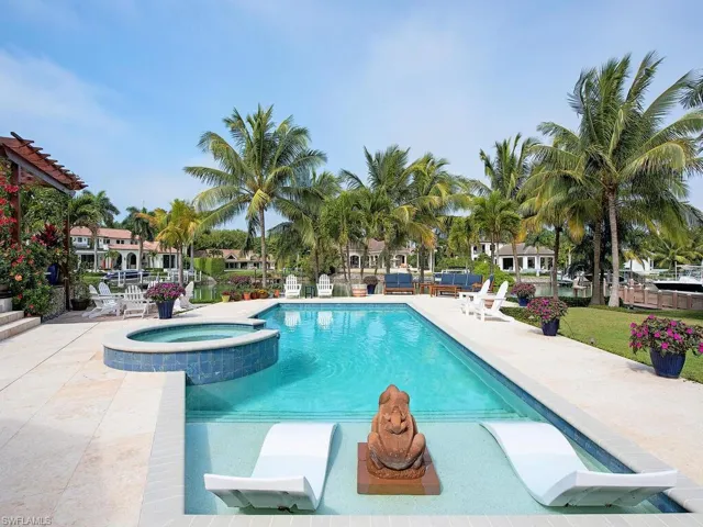 View of swimming pool featuring a patio area and an in ground hot tub