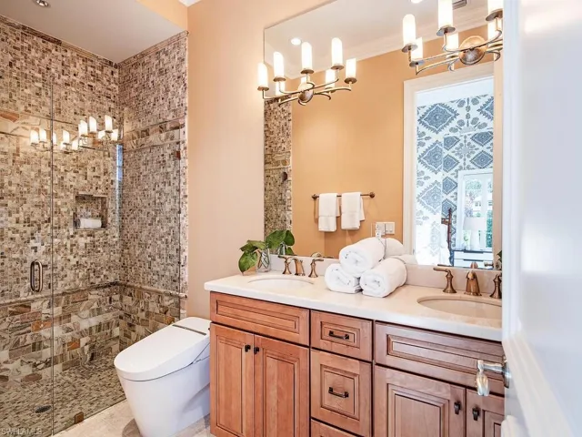 Bathroom with vanity, toilet, and walk in shower