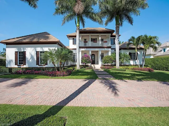 View of front facade featuring a front yard and a balcony