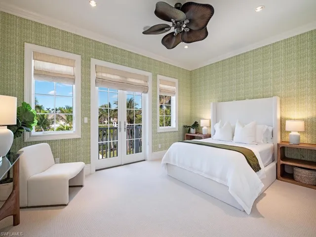 Bedroom featuring ceiling fan, french doors, crown molding, light colored carpet, and access to outside