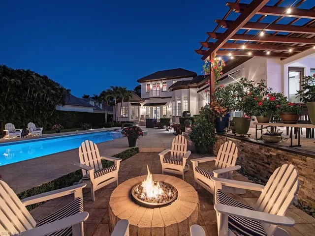 Patio at twilight featuring a pergola and a fire pit