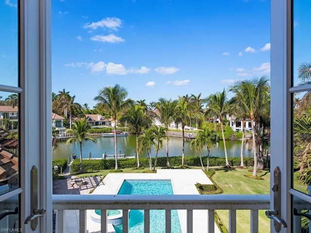 View of pool with a patio, a water view, and a lawn