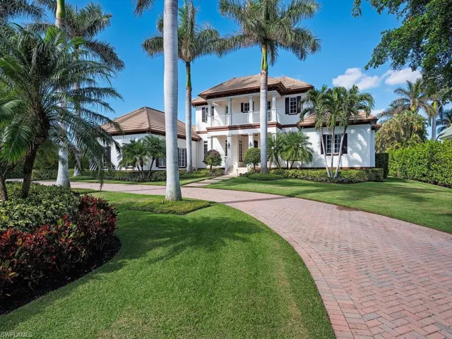View of front of house featuring a balcony and a front lawn