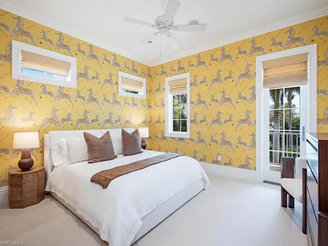 Bedroom with access to exterior, ceiling fan, multiple windows, and ornamental molding