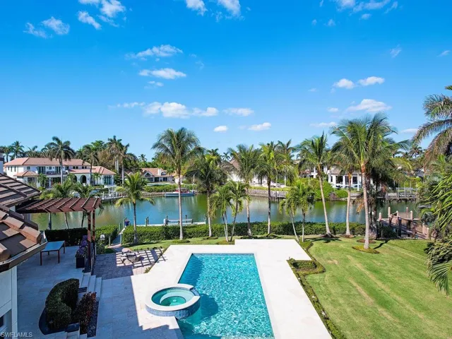 View of pool featuring a water view, a yard, a patio, and an in ground hot tub