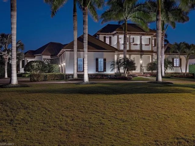 View of front facade with a front yard and a balcony