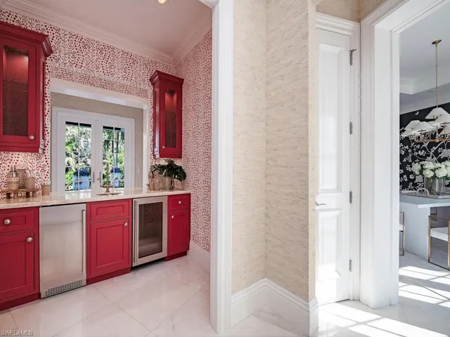 Bar featuring stainless steel fridge, ornamental molding, sink, and wine cooler