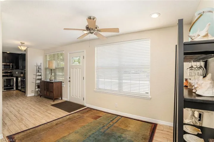 Foyer with hardwood / wood-style flooring and ceiling fan