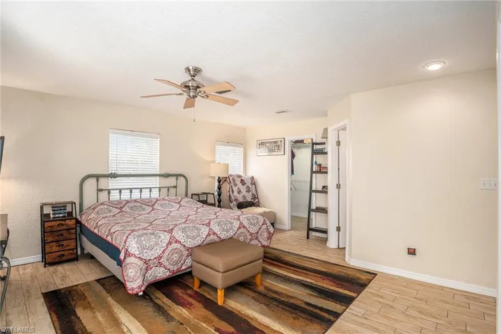 Bedroom featuring ceiling fan and hardwood / wood-style flooring