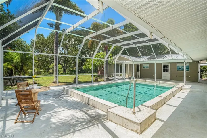 View of swimming pool featuring a patio, a lanai, and a yard