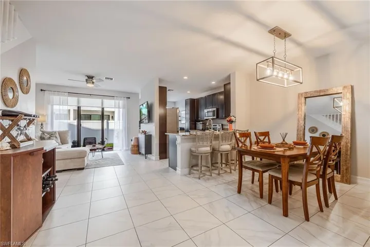 Dining room with a ceiling fan, recessed lighting, light tile patterned flooring, and baseboards