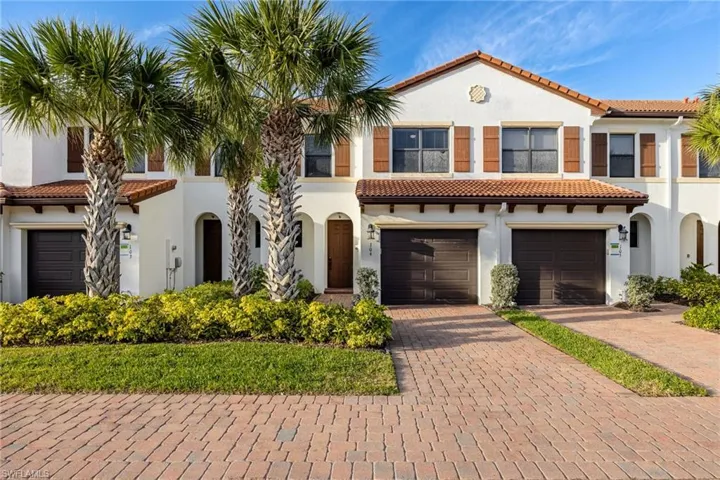 Mediterranean / spanish-style house with a tile roof, decorative driveway, and stucco siding