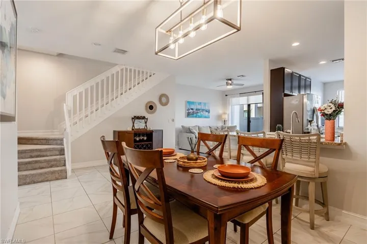 Dining room featuring marble finish floor, recessed lighting, visible vents, stairway, and baseboards