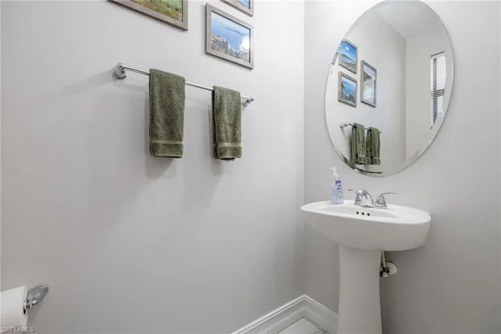 Bathroom featuring a sink and baseboards