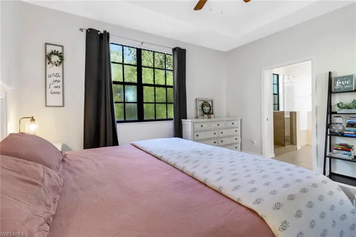 Master bedroom with ensuite bathroom and ceiling fan