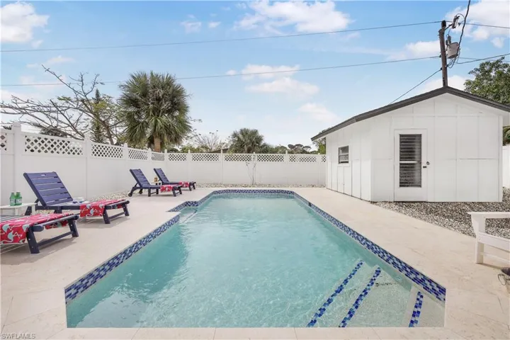 View of pool featuring a fenced backyard, a patio area, and an outdoor structure