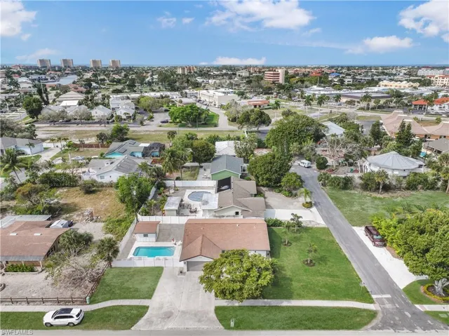 View of property location featuring a pool area and nearby suburban area