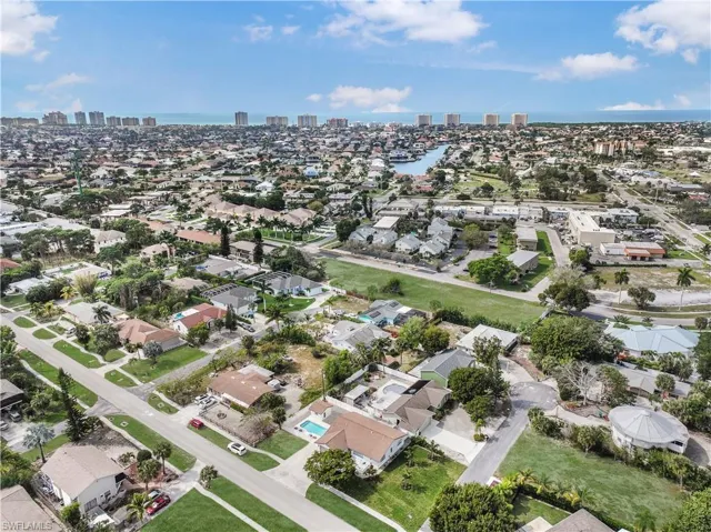Aerial view of property's location featuring nearby urban area and a large body of water