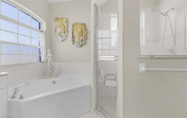 Bathroom featuring a stall shower and a bath
