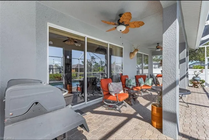 View of patio / terrace featuring an outdoor pool, a ceiling fan, and a grill