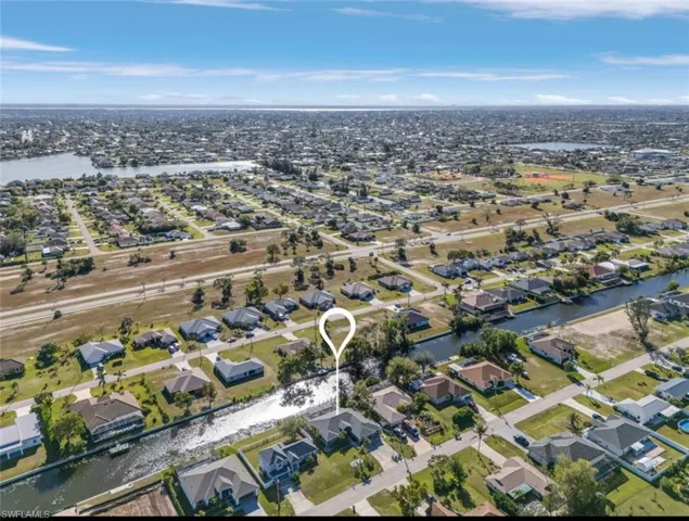 Drone / aerial view with a water view and a residential view