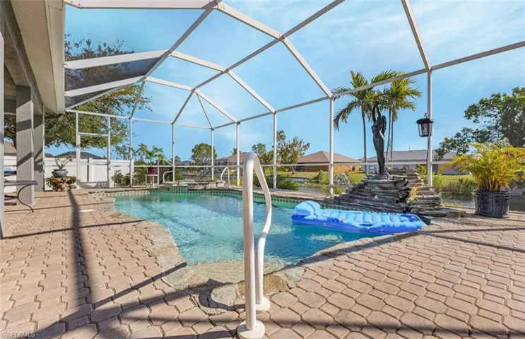 Pool with a patio area and glass enclosure