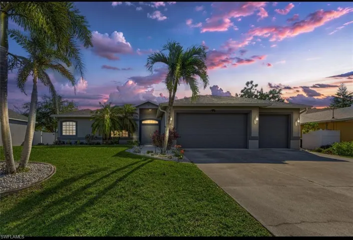 Ranch-style home featuring stucco siding, an attached garage, fence, concrete driveway, and a lawn