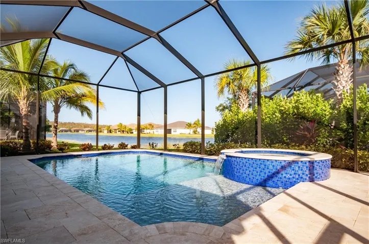 Swimming pool with an in ground hot tub  and a great water view
