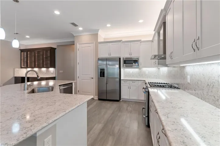Kitchen with quartz counters and appliances with stainless steel finishes