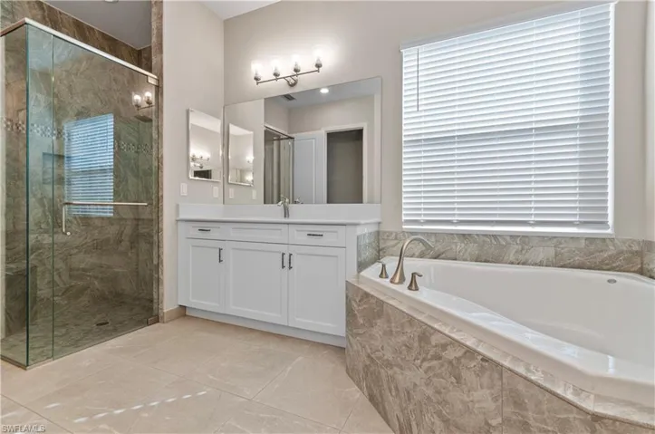 Primary Bathroom featuring separate shower and tub