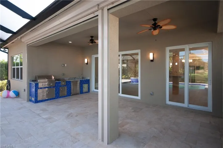 Patio with ceiling fans a full outdoor kitchen