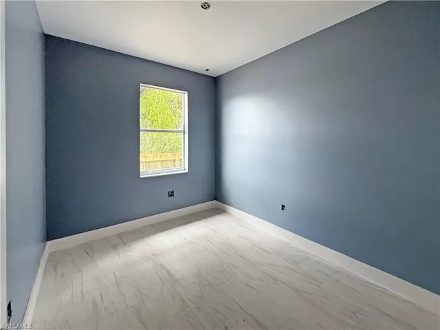 Unfurnished room with baseboards