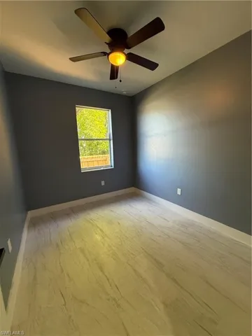 Spare room with light wood-type flooring and ceiling fan
