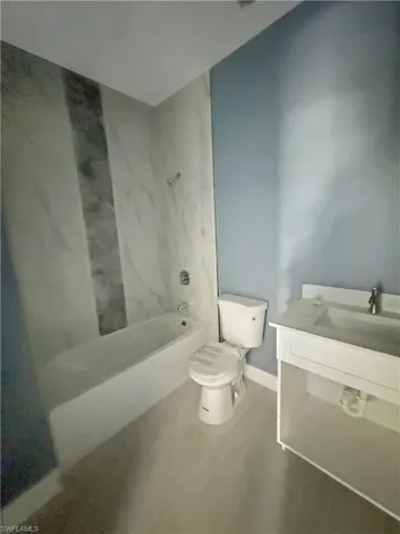 Full bath featuring vanity and bathing tub / shower combination