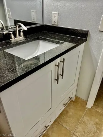Interior details with a textured wall and vanity