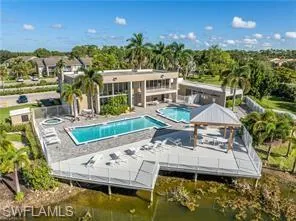 Community pool with a patio and a water view