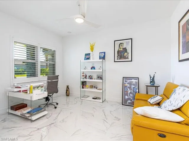 Office featuring light marble finish flooring and ceiling fan