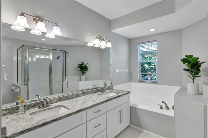 En-suite Master Bath showing double sinks, granite counters and Garden Tub
