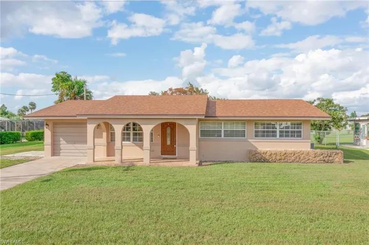 View of front of house with a front lawn and covered porch