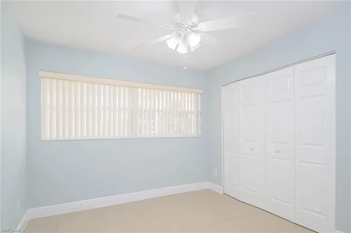 Unfurnished bedroom featuring ceiling fan and a closet