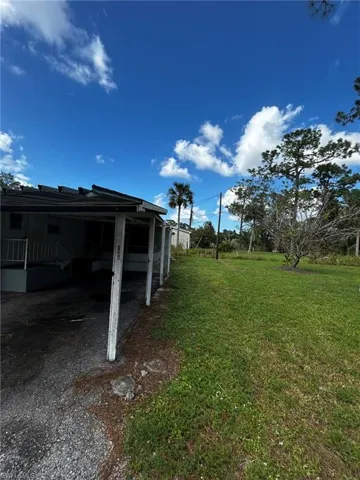 View of yard with a carport