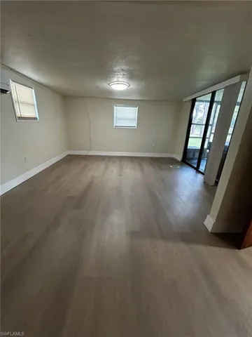 Unfurnished room featuring a textured ceiling and wood-type flooring