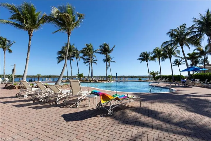 Community pool with a patio and a water view