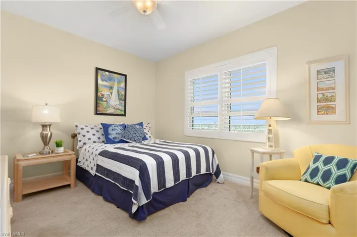 Bedroom featuring carpet floors, baseboards, and ceiling fan