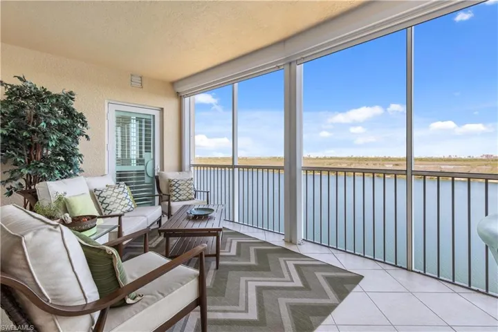 Sunroom / solarium with a water view and outdoor lounge area