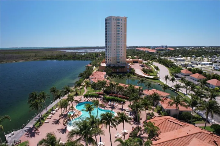 Aerial view of a pool area and a nearby body of water