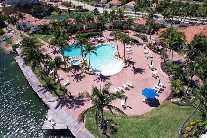 Aerial view of property's location featuring a pool area and a large body of water